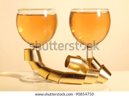 Color photo of wine glasses and a gold ribbon