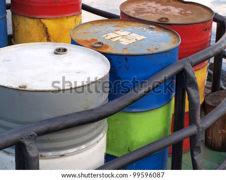 Color photograph of steel drums with gasoline