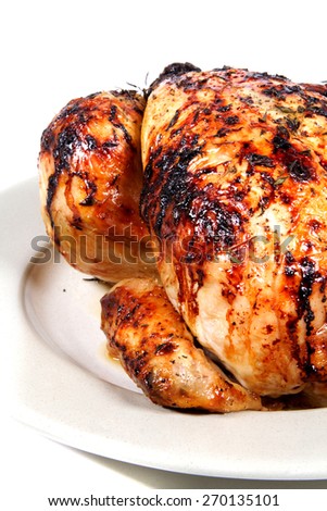 Whole roast chicken on a serving plate