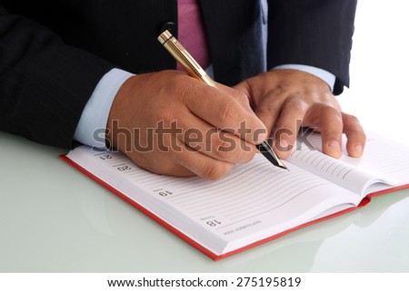 Man writing in an appointment book