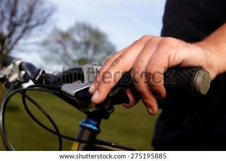 Hand on a bike handlebar