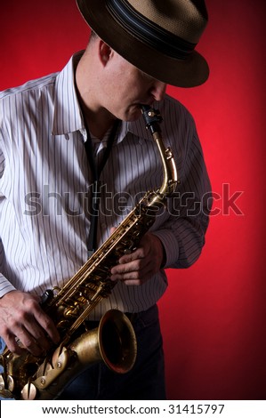 A professional saxophone player isolated against a red background in the vertical format with copy space.