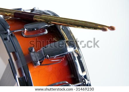 A red fade color snare drum with sticks isolated against a white background in the horizontal format.