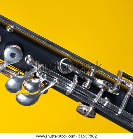 An oboe up close isolated against a yellow background in the square format with copy space.