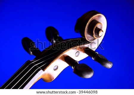 A violin viola scroll isolated on a blue background in the horizontal format with copy space.