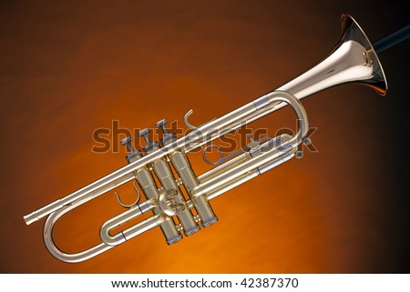 A brass gold trumpet cornet music instrument against a spotlight gold background.