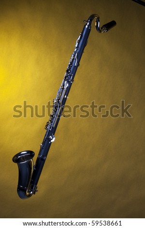 A bass clarinet isolated against yellow background in the vertical format with copy space.
