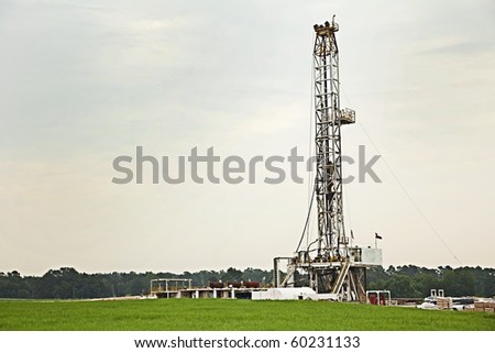 Oil well, rig, field, grass, green, sky, energy, drilling, gray, pump, equipment, swell head, horizontal format,