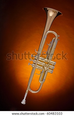 A professional gold trumpet cornet isolated against a spotlight gold background.