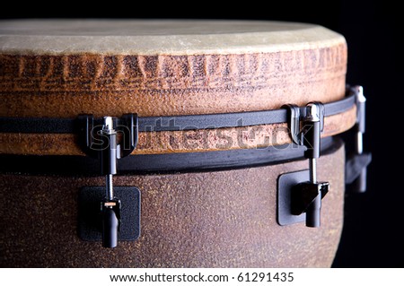 A brown African or Latin Djembe conga drum isolated on black background.