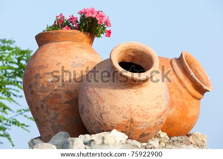 Flowers in the old clay jars in the city of Nesebar, Bulgaria