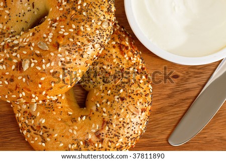 Freshly baked seeded bagels with rich smooth cream cheese