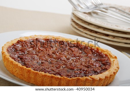 Fresh backed whole pecan pie ready to be cut and served - high key shot with space in upper left for graphics or text