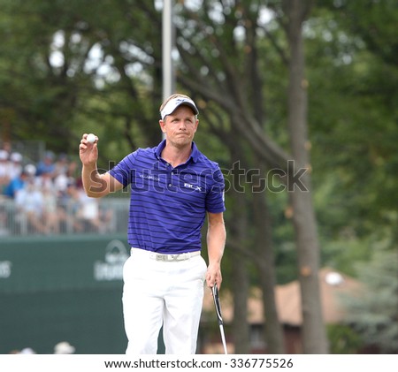 EDISON,NJ-AUGUST 30:Luke Donald waves to fans after his final putt on the 18th hole during the final round of the Barclays Tournament held at the Plainfield Country Club in Edison,NJ,August 30,2015.
