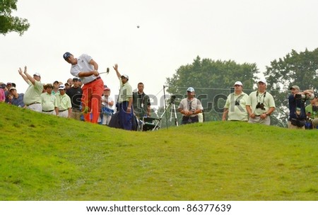 EDISON,NJ-AUGUST 27: Golfer Matt Kuchar takes a shot out of the rough during the final round of the Barclays tournament held at the Plainfield Country Club on August 27,2011 in Edison,NJ.