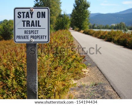 Restriction sign to stay on bike trail.