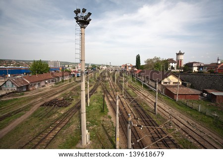 Railway junction. Perspective of crossing rails, traffic lights and train.