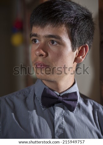 Formal portrait of a teenage boy in a suit and tie.