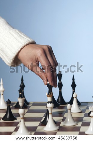 hand of a player making ocombinatie in chess