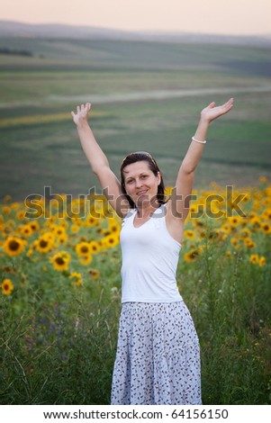 lady full of life with sunflower field