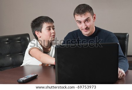 portrait of two young men in front of computer