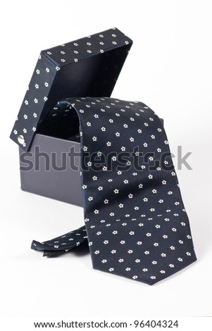black box from which hangs a tie white background, isolated