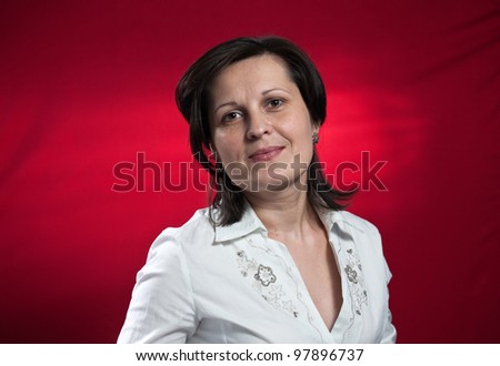 woman in white blouse on red background