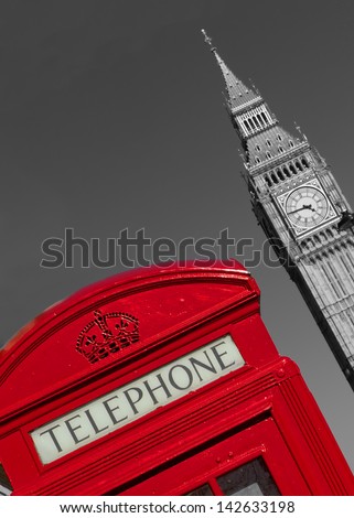 Red London phone box with black and white Big Ben in the background.