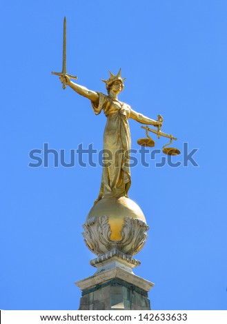 Close up of the golden statue on top of the Old Bailey the Central Criminal Court of England and Wales, a court in London and one of a number of buildings housing the Crown Court