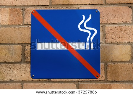 Blue no smoking sign on a red brick wall