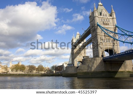 Shot of Tower Bridge from the south west side of the river Thames with the White Tower of the Tower of London in the distance