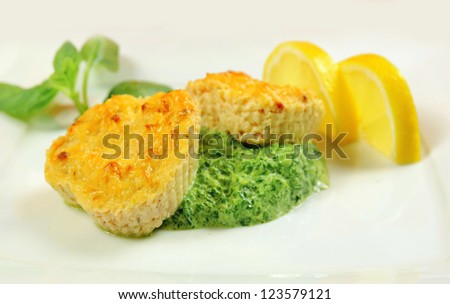 Fishcakes with lemon, basil leaves and green sauce in a restaurant