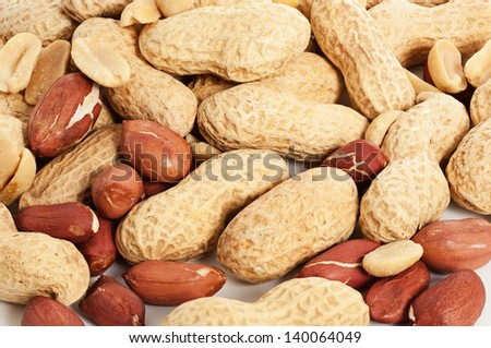 Many peanuts in shell on white, macro