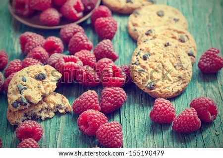 Fresh vintage raspberry on the blue wooden rustic desk with cookies
