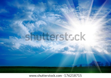 Dramatic clouds with sun on the blue sky on the sunset