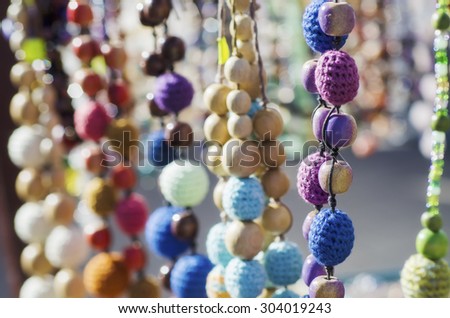 Colorful vivid handmade beads on the market, vintage hipster background