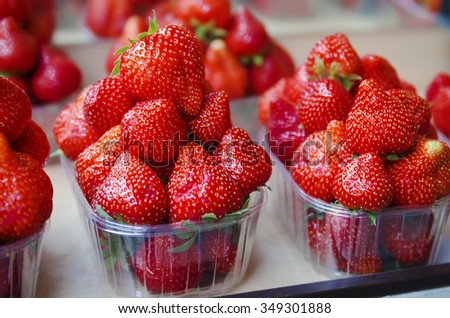 Fresh strawberry at market in plastic boxes, local food healthy background