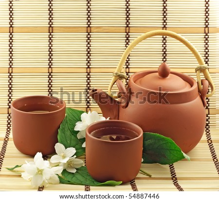 Clay set with green tea and jasmin flowers