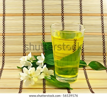 stock-photo-fresh-green-tea-with-jasmin-white-flowers-56539576.jpg