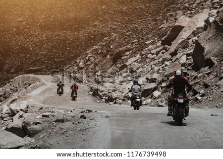 Group of touring bigbike motorcycle riding on curve road, rock mountain, journey and adventure trip