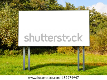 Billboard with empty screen standing in a field