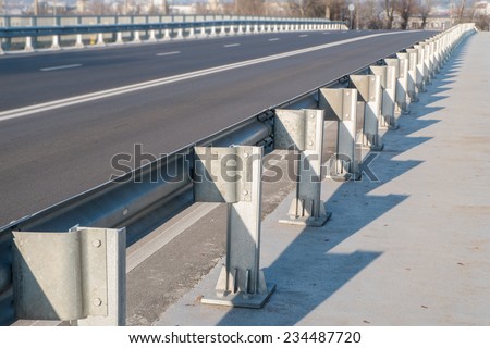 Anodized safety steel barrier on freeway bridge