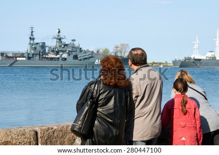 People on the boardwalk watching the Russian naval fleet