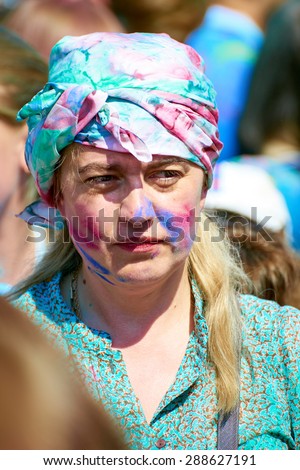 KALININGRAD, RUSSIA - JUNE 12, 2015: Unidentified woman during Holi Festival of Colors, the event is timed to the Day of Russia.