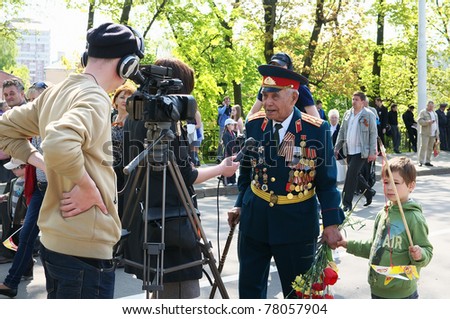 KALININGRAD, RUSSIA - MAY 9: Journalists interview an unidentified veteran at the eternal flame during the 66th anniversary Victory Parade  on May 9, 2011 in Kaliningrad, Russia