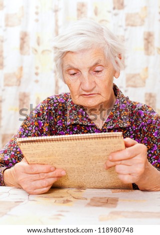 Elderly happy woman read something