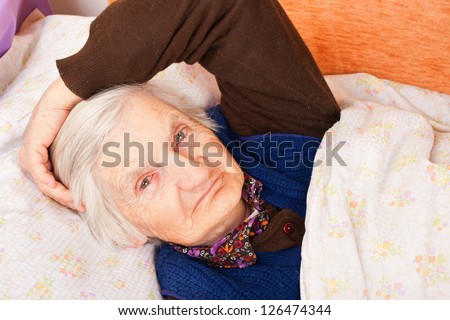 Elderly lonely woman in the bed