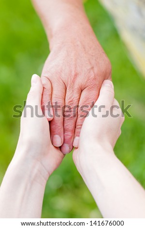 The young woman support the elderly woman