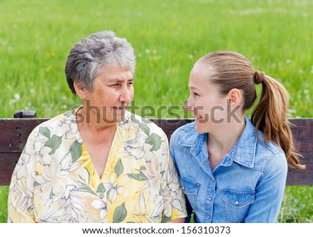 Elderly woman tells a story to her daughter