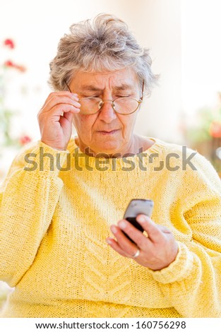 Elderly woman sitting on the veranda and waiting for a call